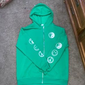 Green “Nothing feels real anymore” zip up jacket.